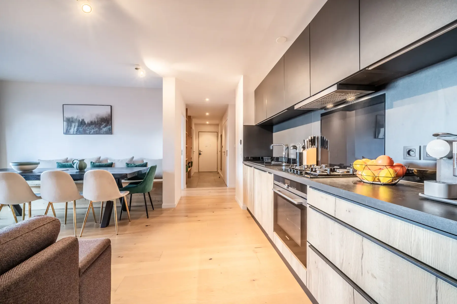An open-plan kitchen and dining area with a long counter and table.