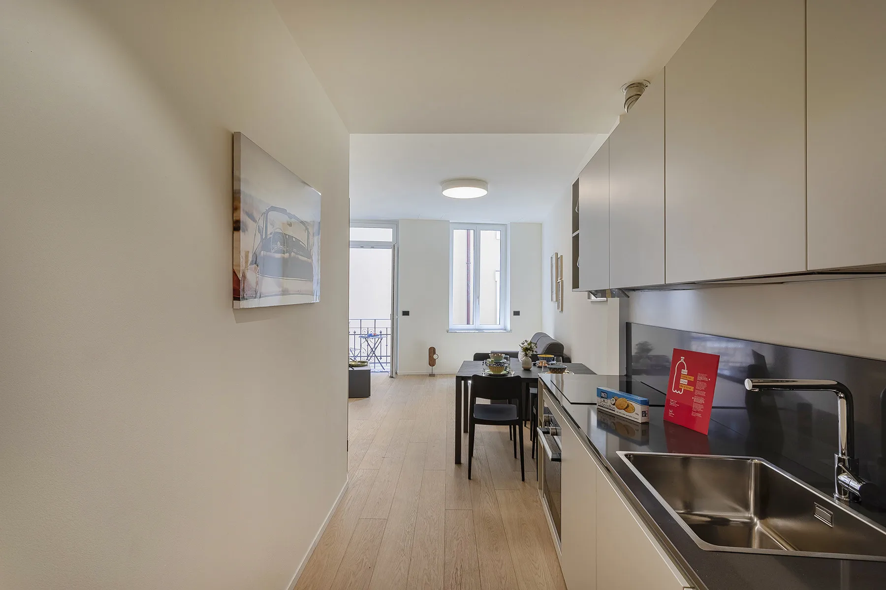 A bright kitchen and dining area with a table beside the counter.