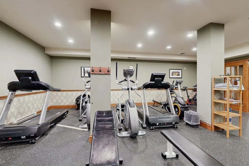 A fitness room with treadmills and other exercise equipment.