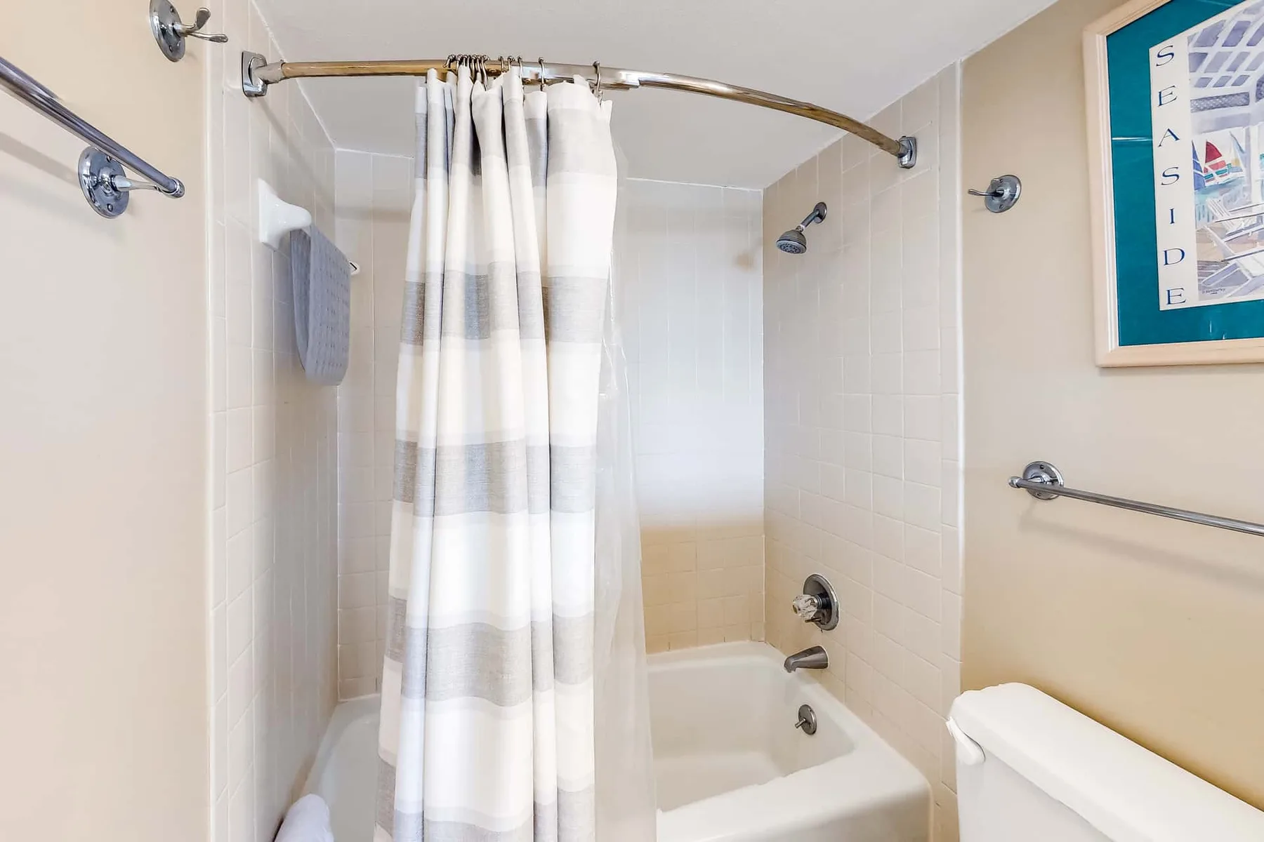 A bathroom with a bathtub and a striped shower curtain.