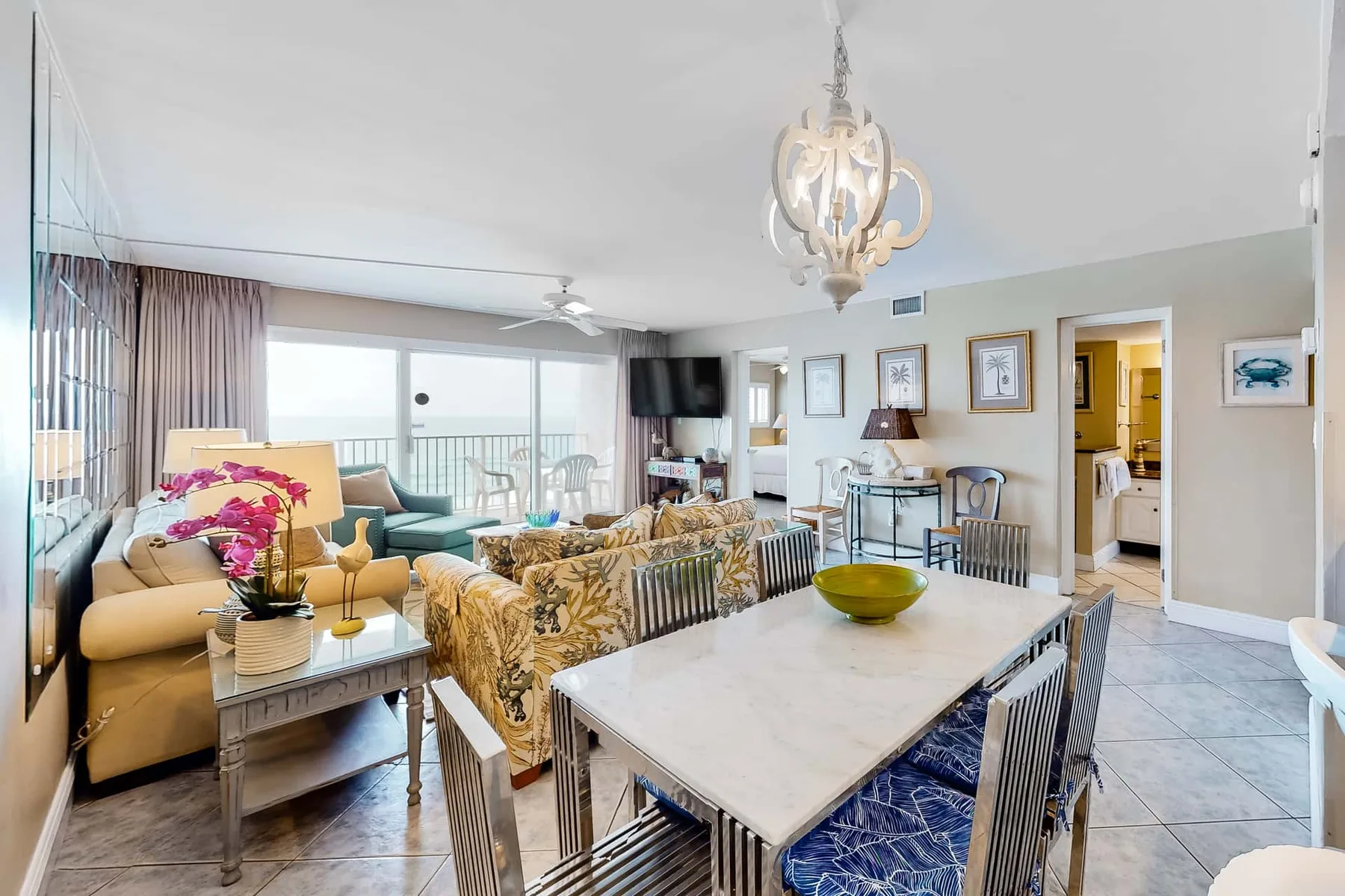 An open-plan living and dining area with seating beside large windows.