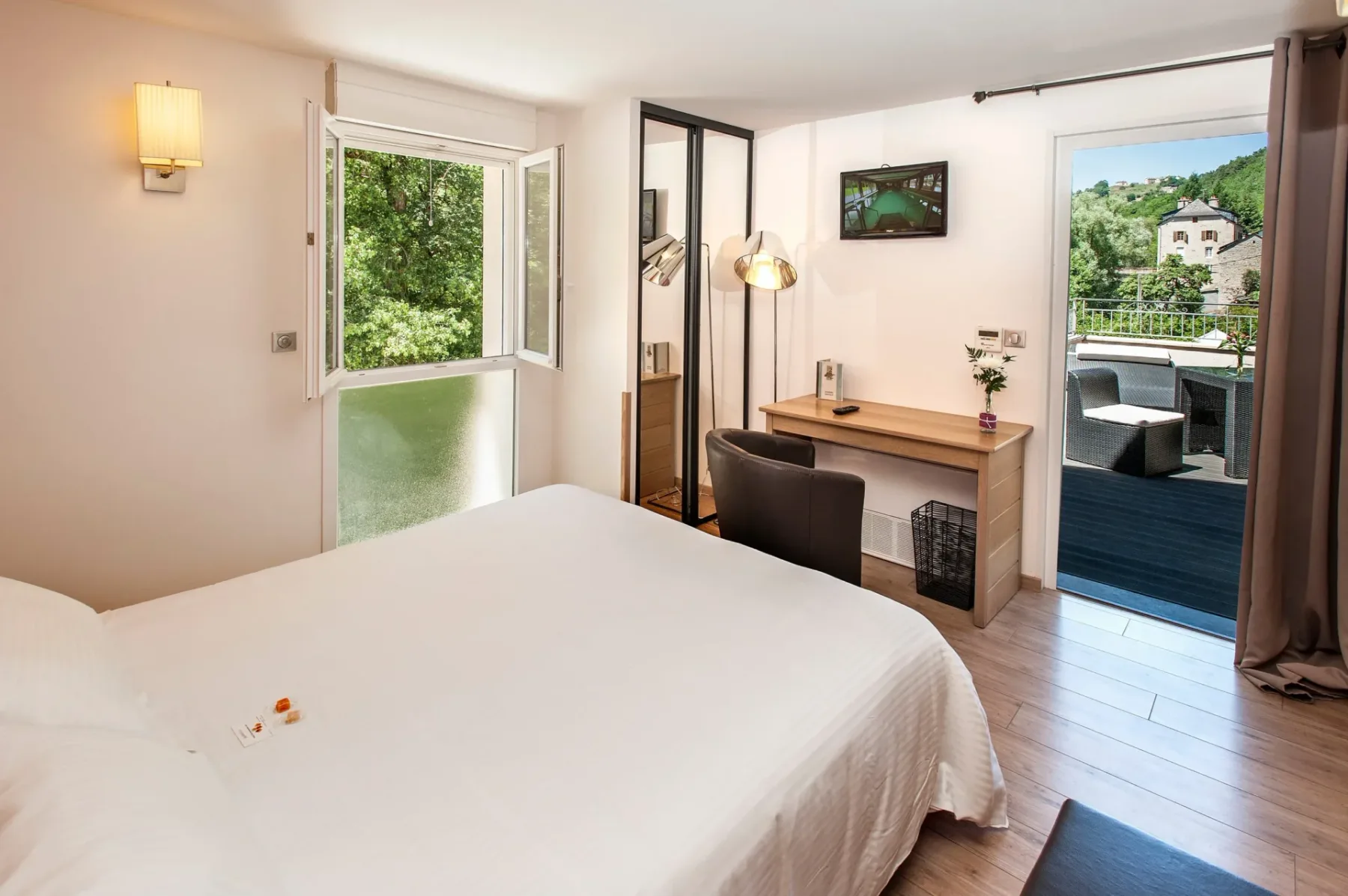 Habitación de hotel moderna con balcón y vistas a zonas verdes