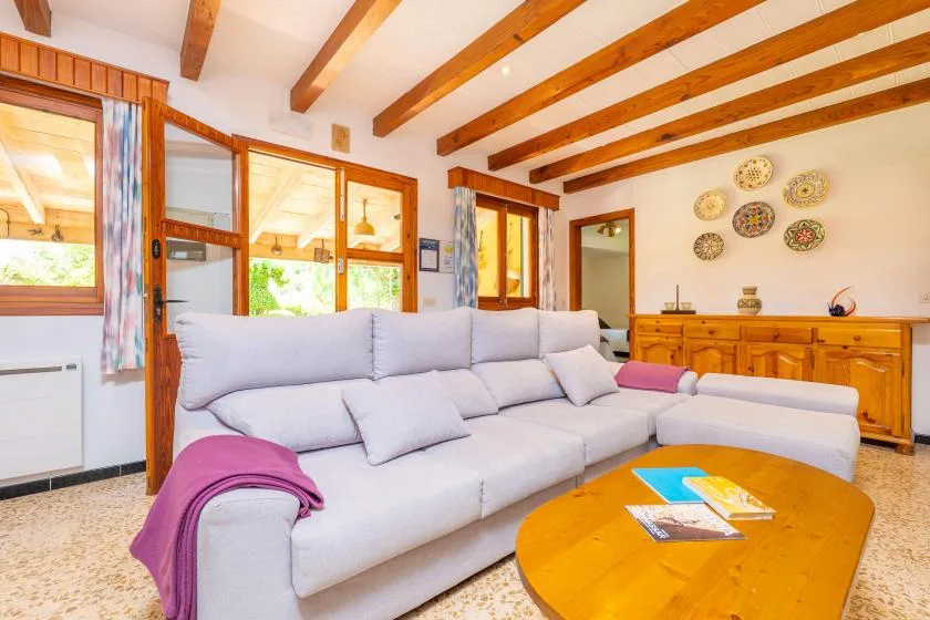 A living room with a light-colored sectional sofa and wooden coffee table.