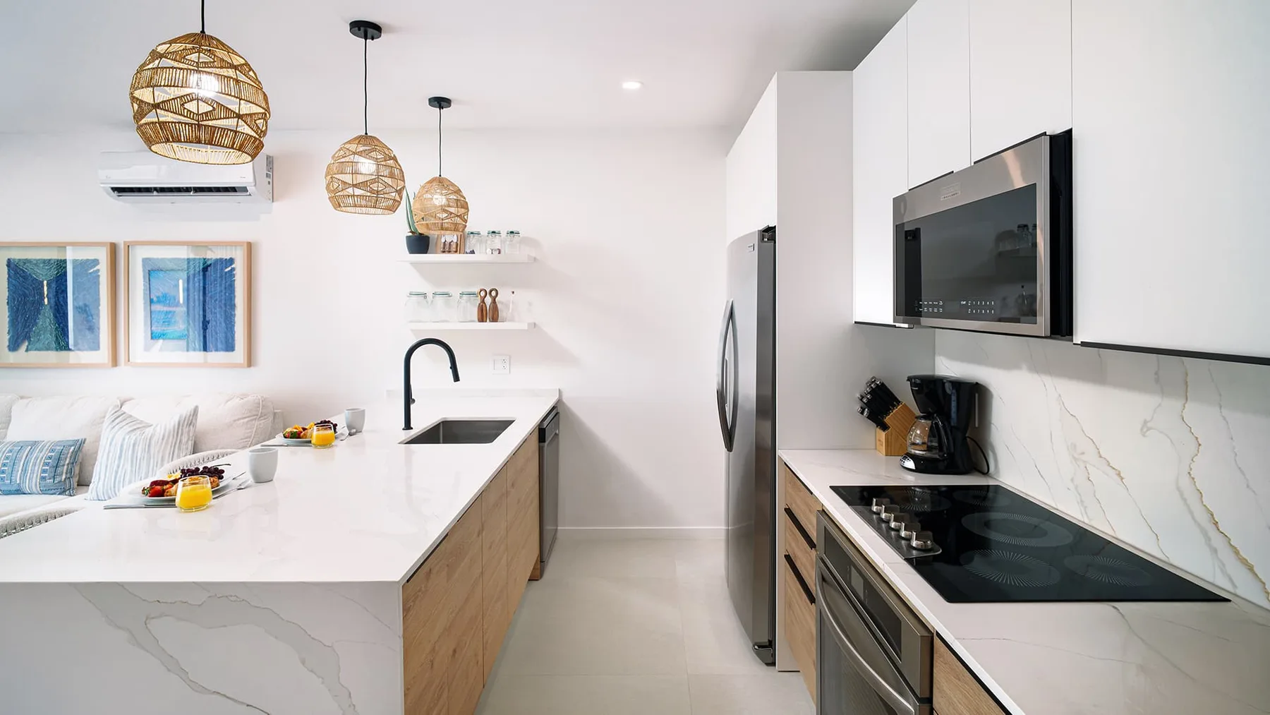 A bright modern kitchen with a white island and built-in appliances.