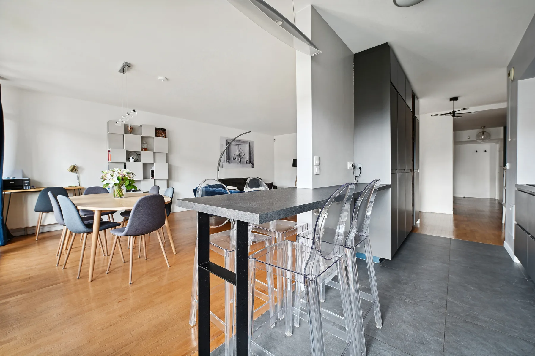 An open-plan kitchen and dining area with a long counter and dining table.