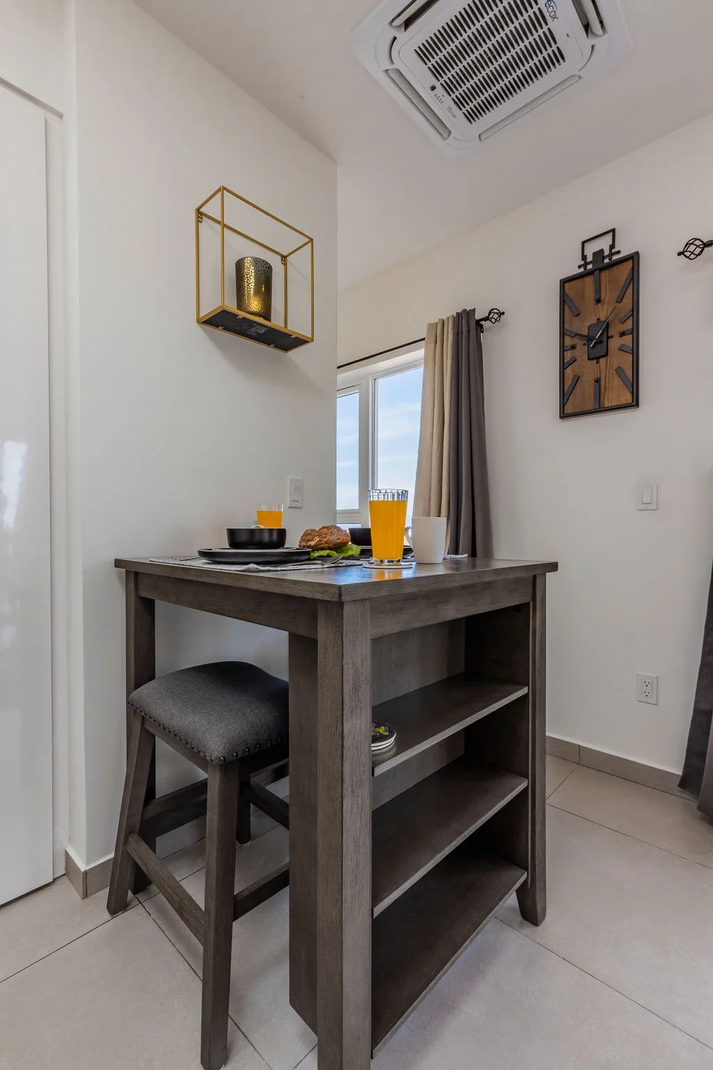 Enjoy your morning coffee or a quick bite at this cozy bistro table, perfectly positioned to catch natural light streaming through the window.