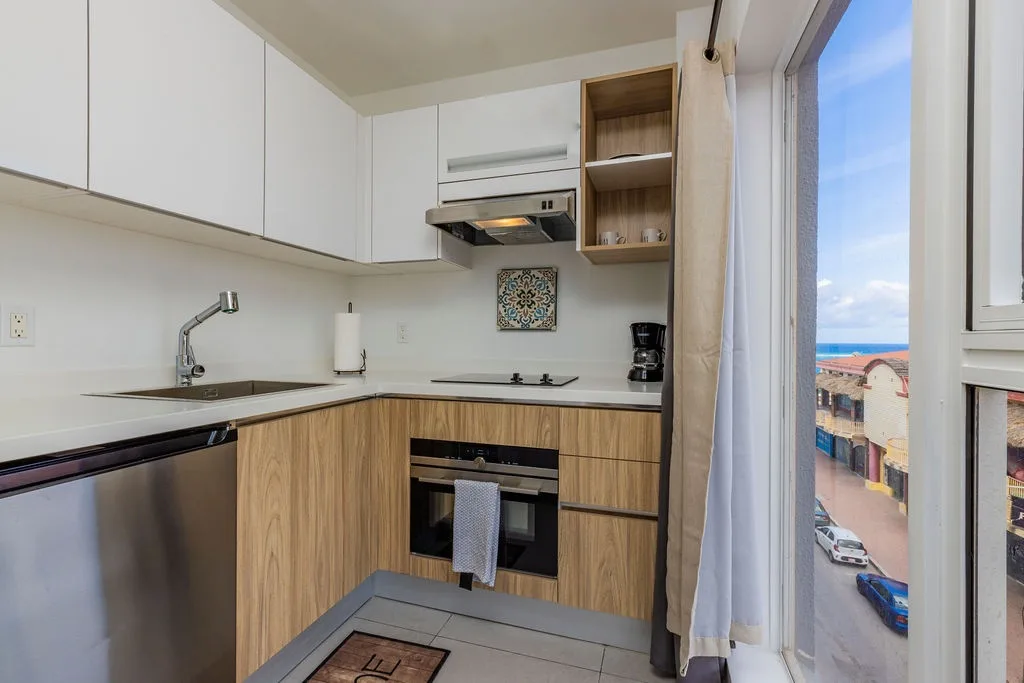 Your modern kitchen opens to stunning sea views, with sleek wood-grain cabinets, stainless appliances, and everything you need to cook up a memorable vacation meal.