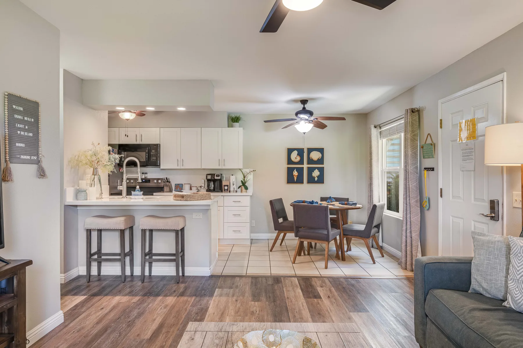 An open-plan living area features a kitchen counter and dining table.