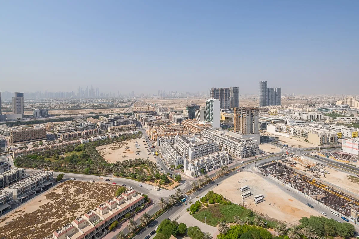 Aerial view of a developing urban area with roads and high-rise buildings.