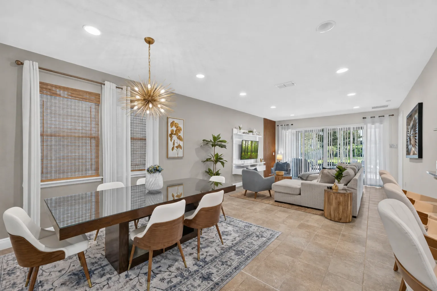 An open-plan dining and living room with a long table and seating area.