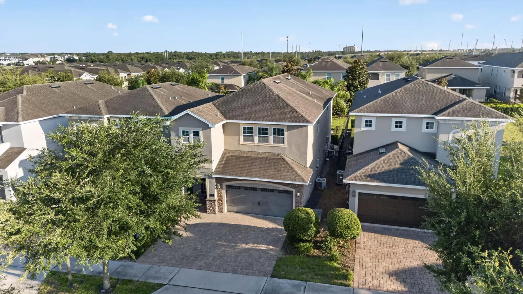 Aerial view of a residential neighborhood with rows of houses and driveways.