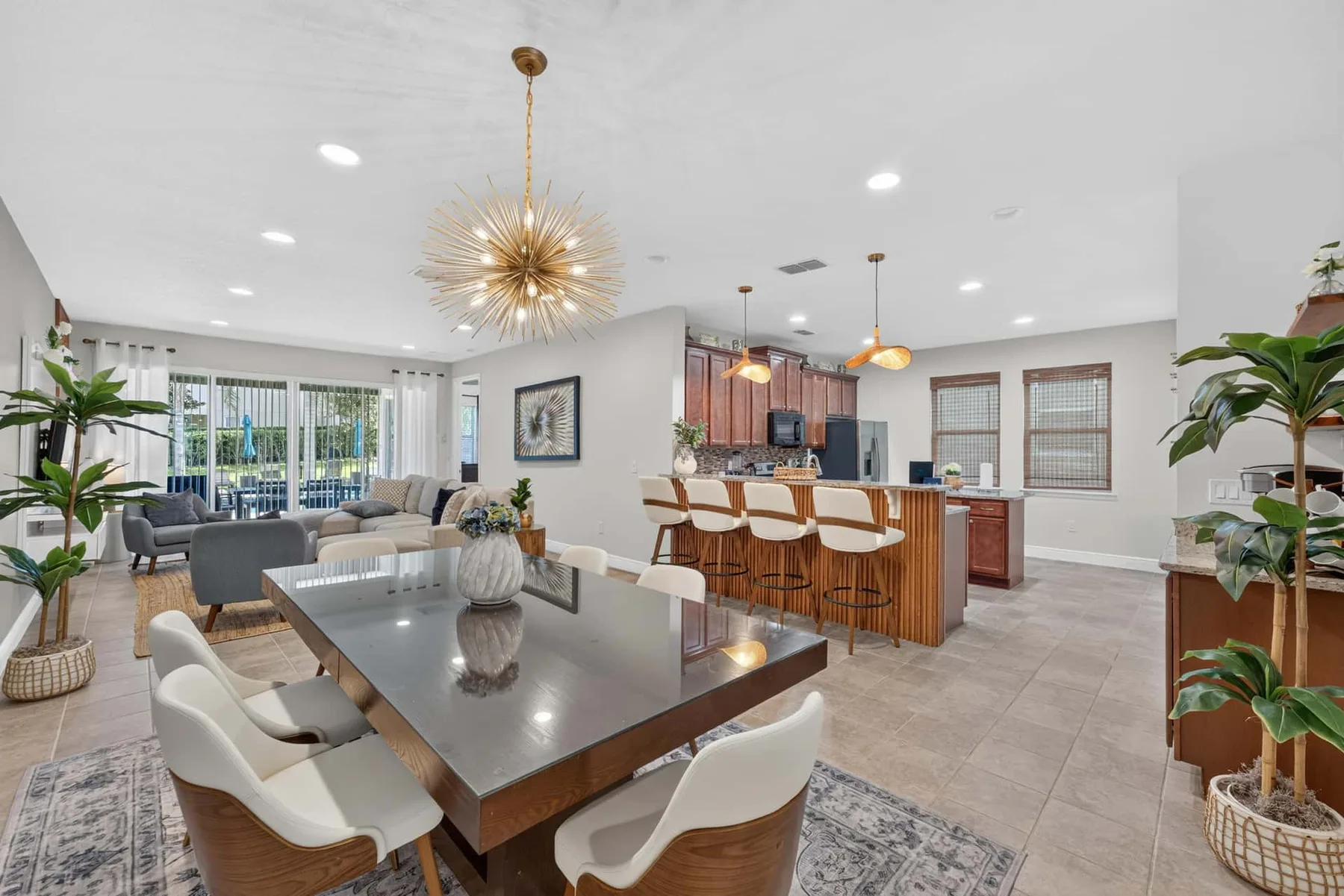 An open-plan living and dining area connects to a kitchen with a breakfast bar.