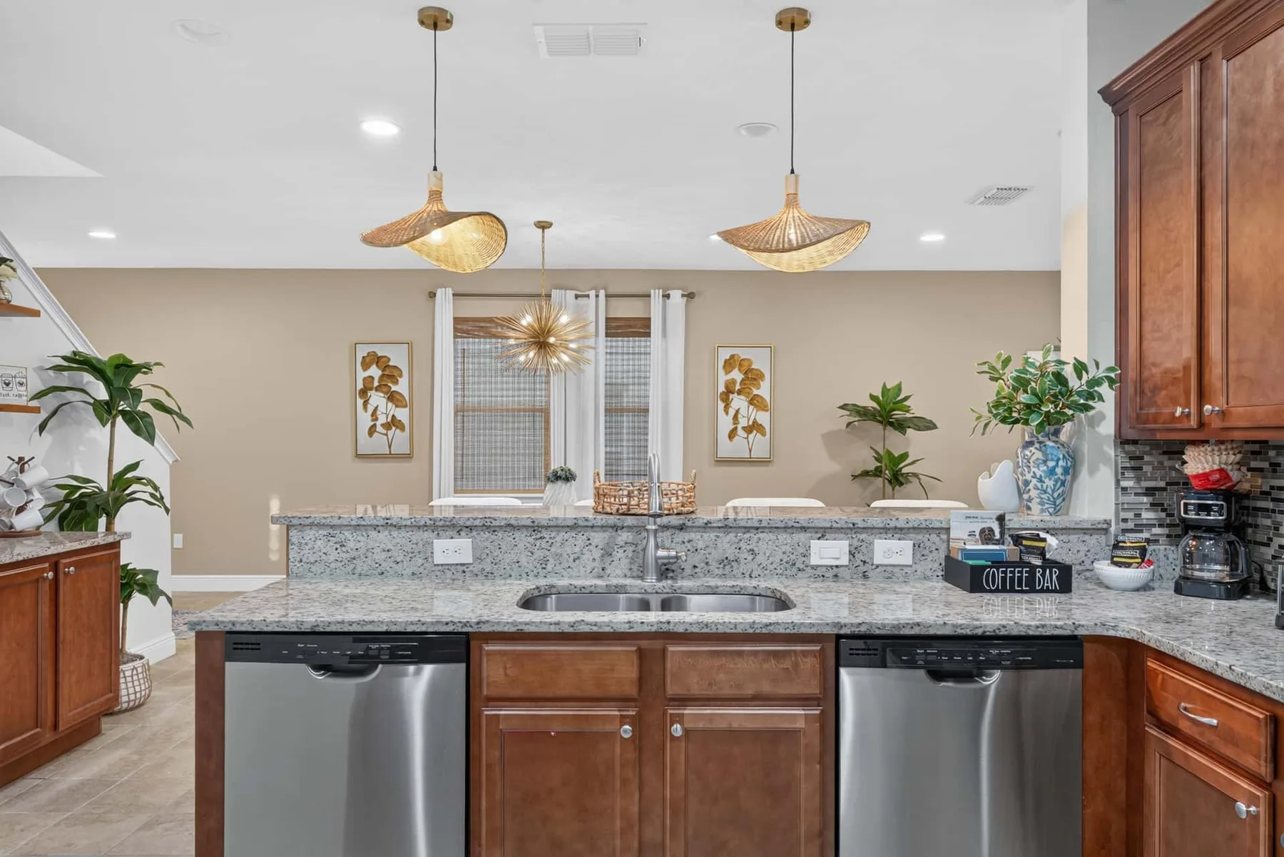 A kitchen with a central island, stainless steel appliances, and wooden cabinets.