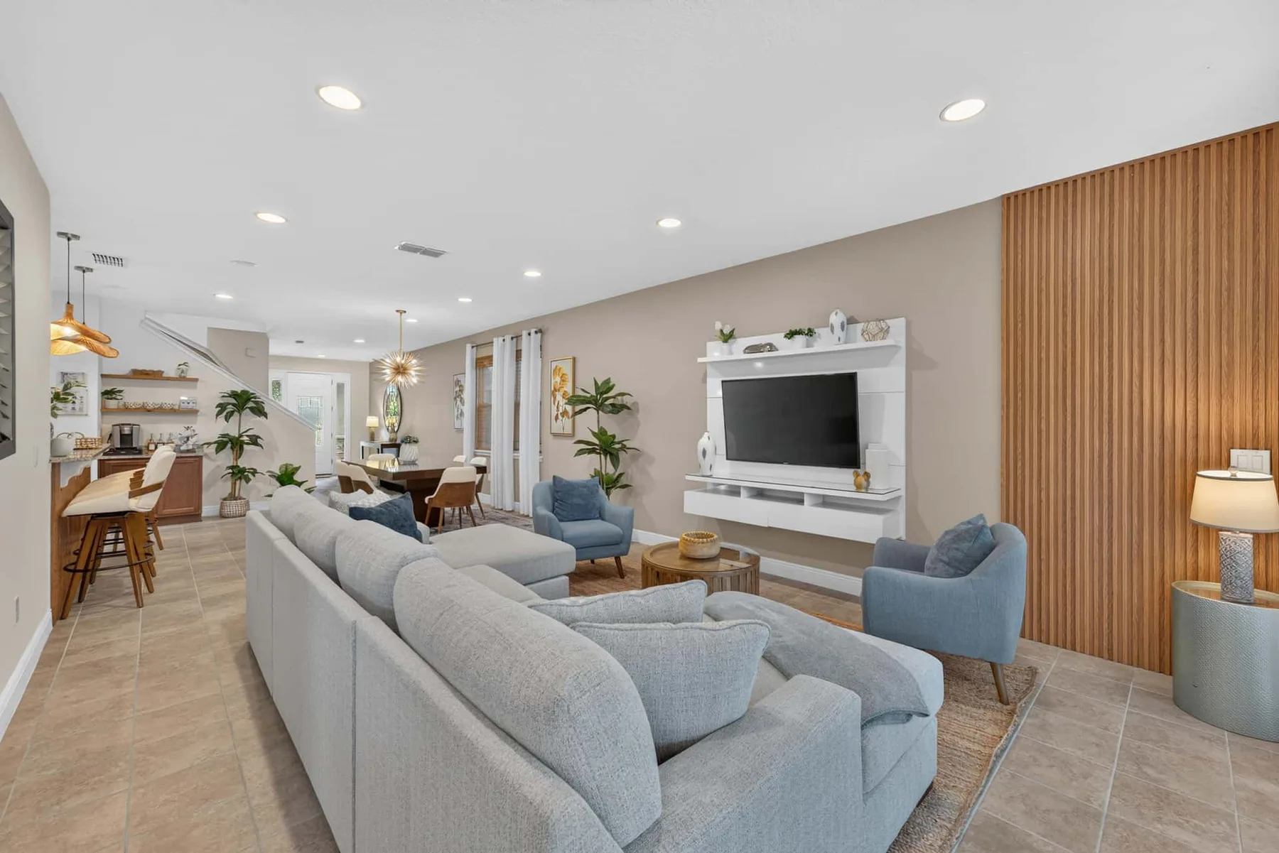 A living room with seating arranged around a television.