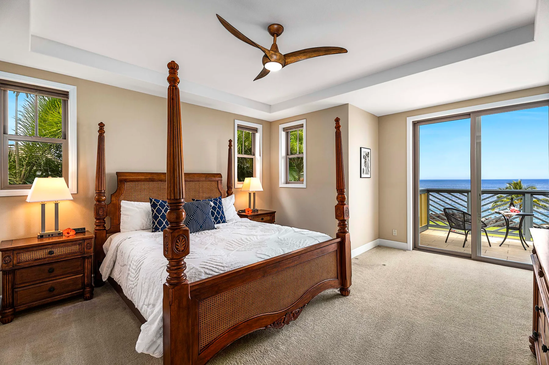 A bedroom with a wooden bed and sliding glass doors opening onto a balcony.