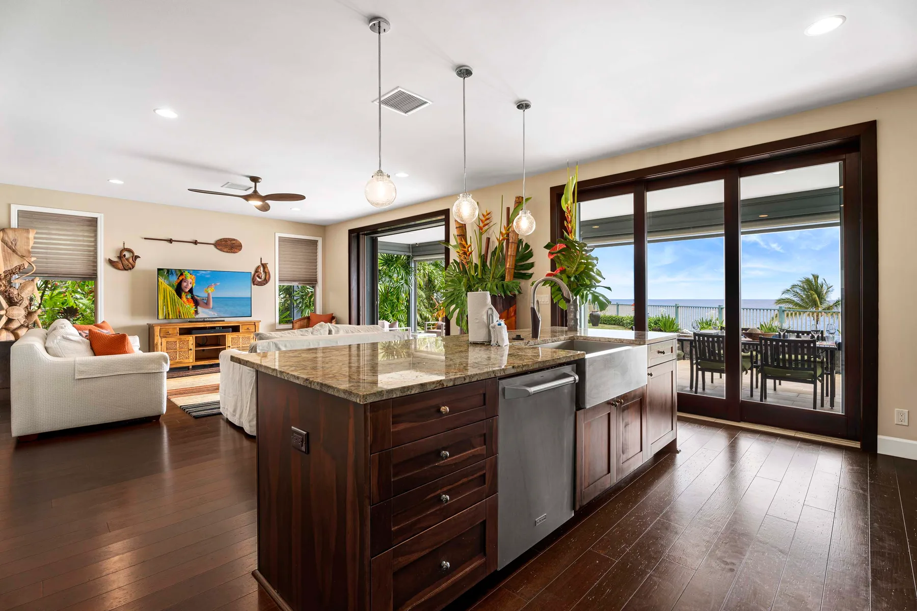 A spacious kitchen with a central island opens onto a dining patio.