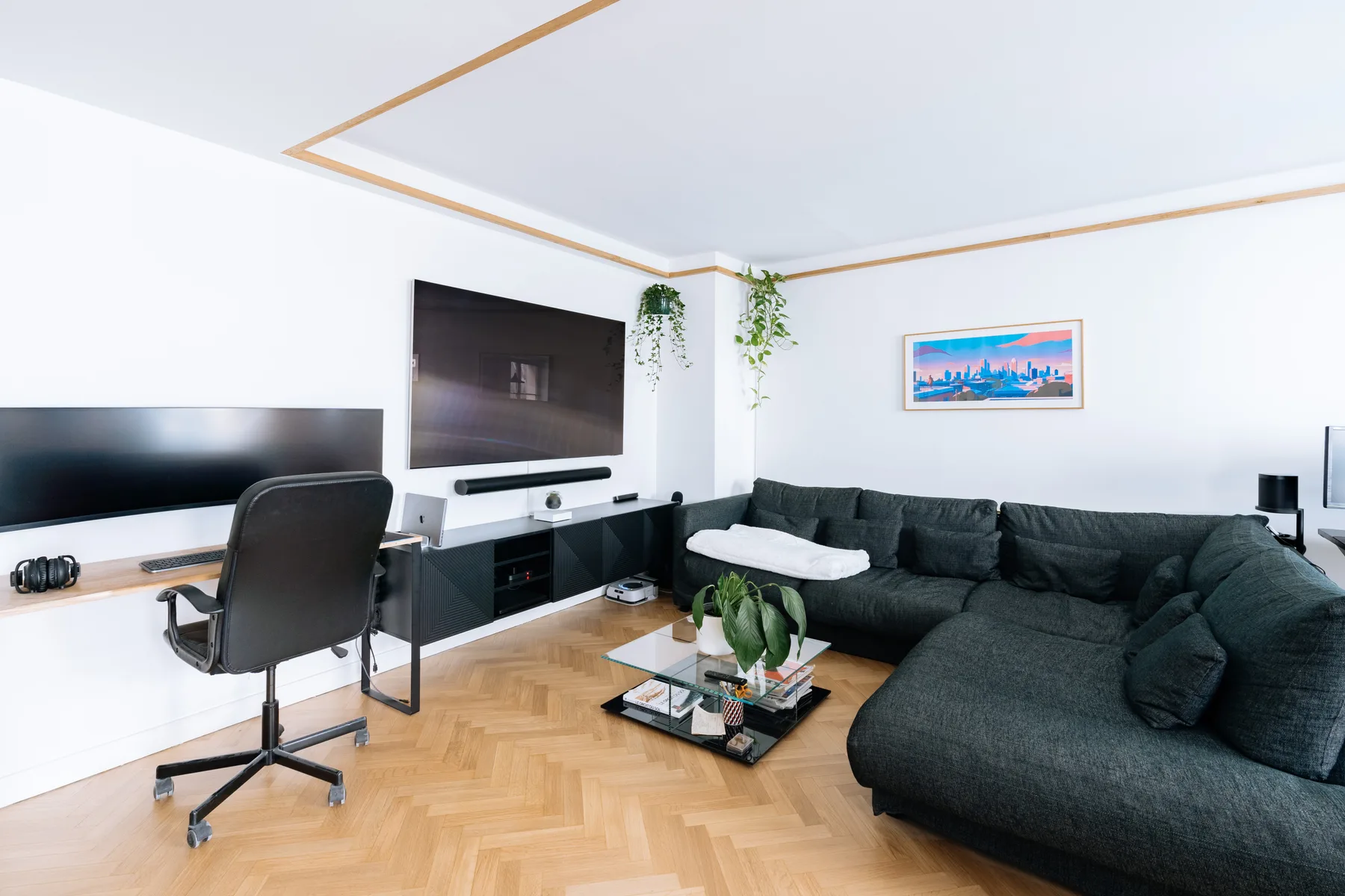 Living room with dark seating, a television, and a coffee table.