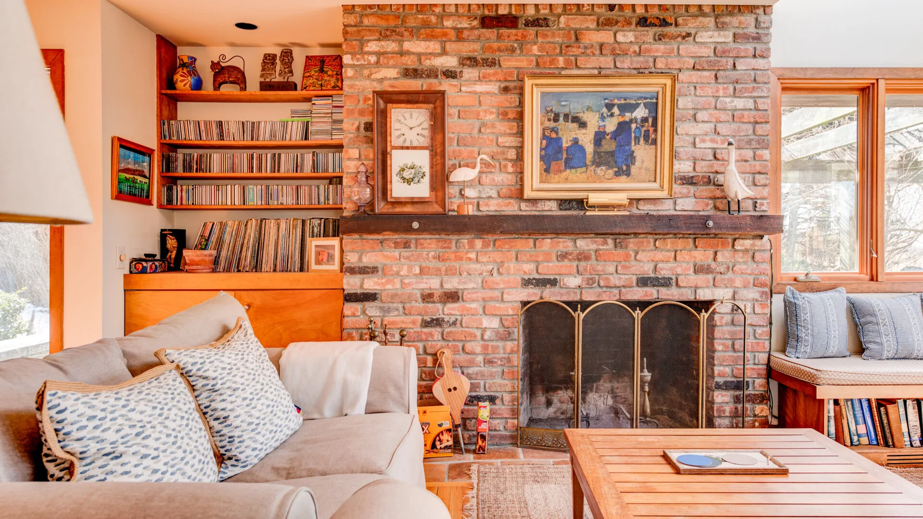 A living room with a brick fireplace and seating.