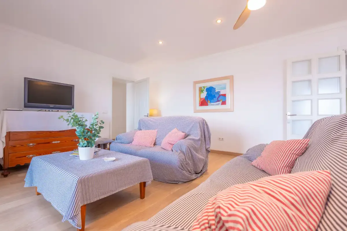 A living room with seating, a television, and a coffee table.