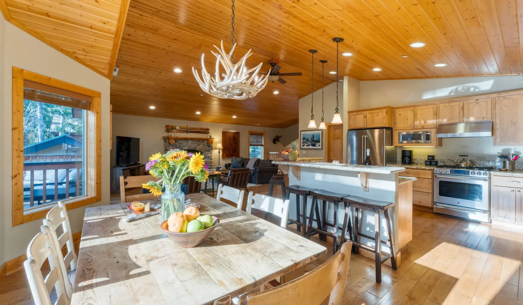 An open-plan kitchen and dining area with a large wooden table.