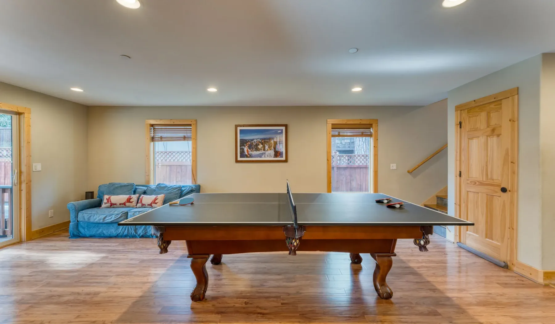 A recreation room with a ping-pong table and seating.