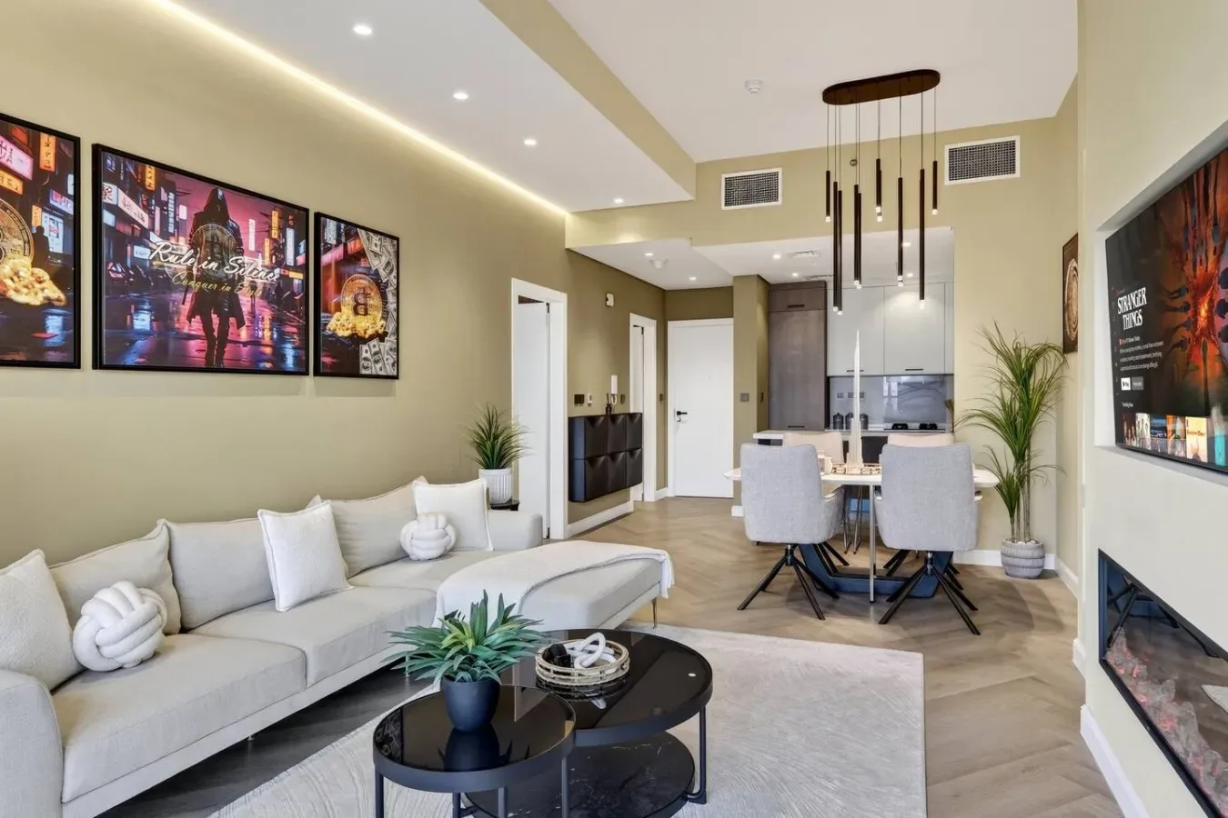 A bright living and dining area with seating, a coffee table, and a dining table.