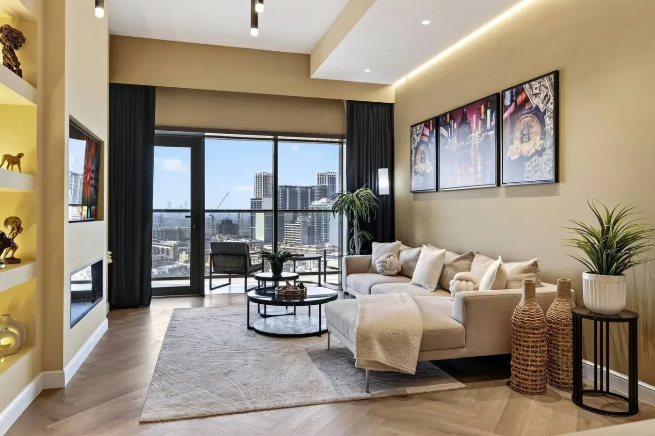 A modern living room with light seating, large windows, and a city view.