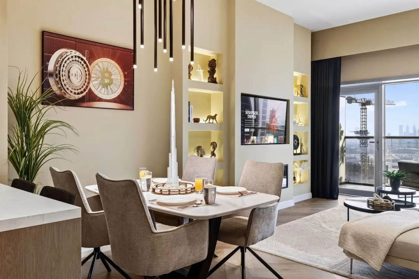 A dining area with upholstered seating and a wall of display shelves.