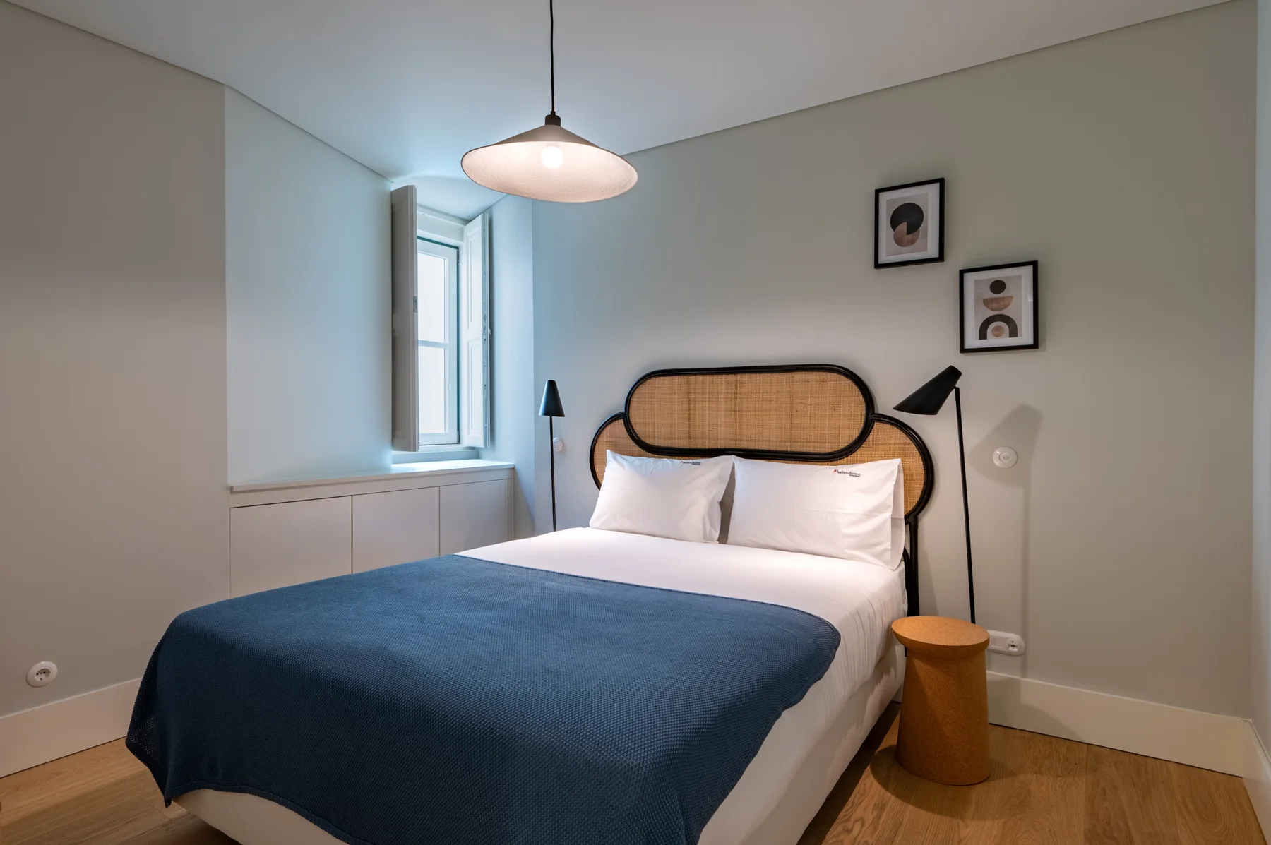 A bedroom with a bed and a window.