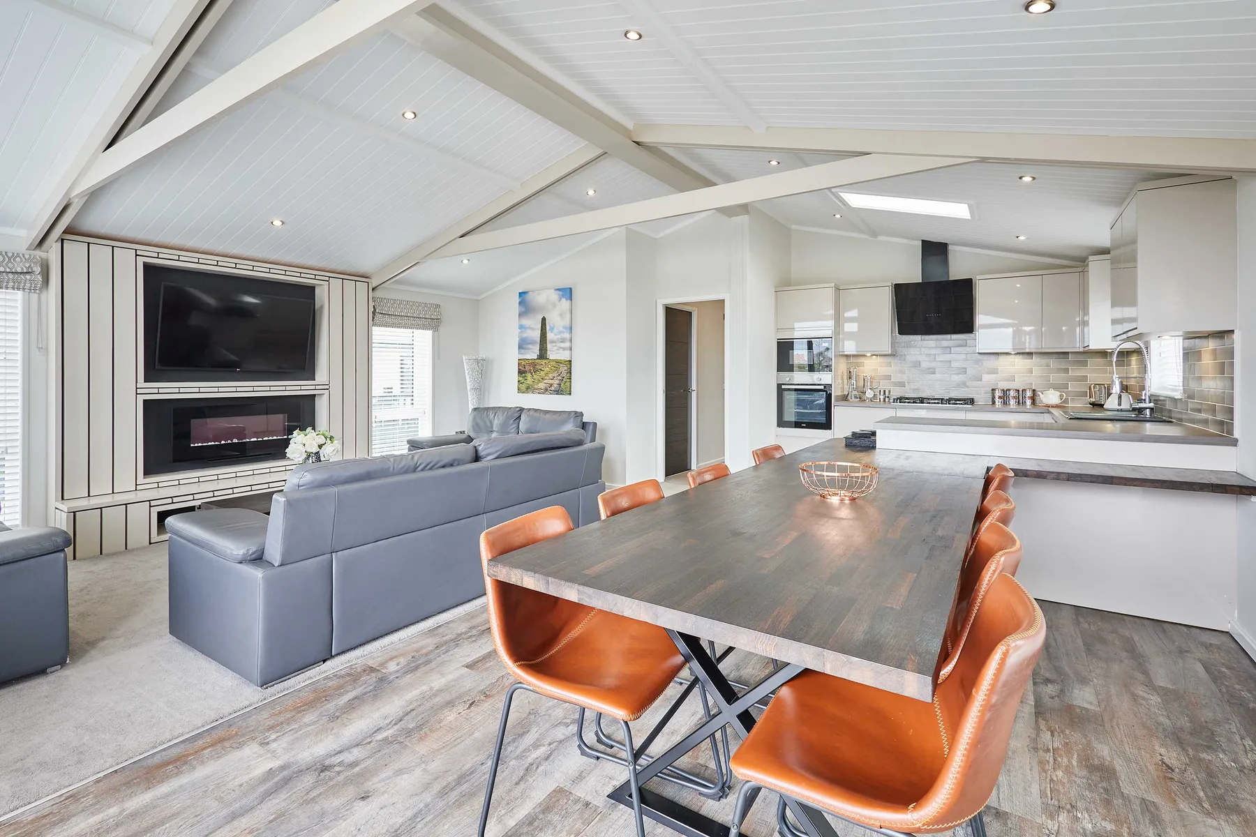 Una sala-comedor de concepto abierto con cocina y una mesa de comedor larga.