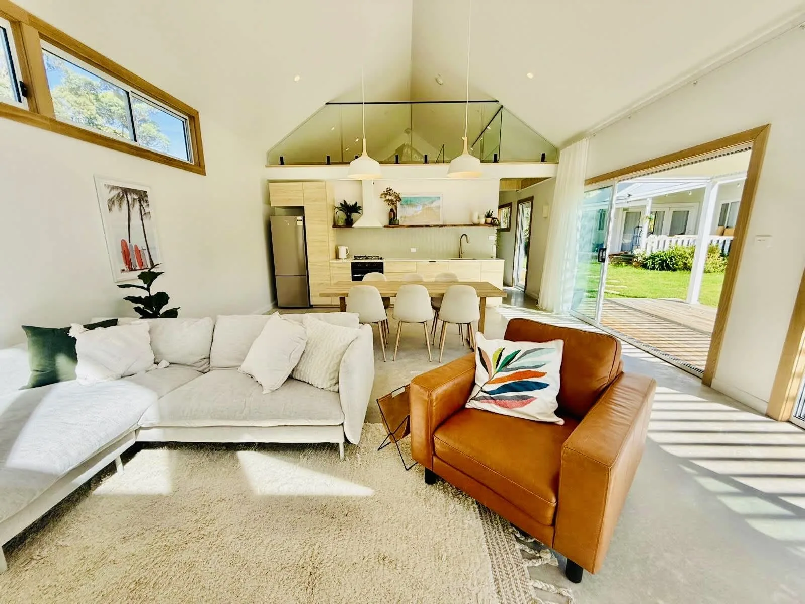 An open-plan living and dining area with seating and a kitchen.