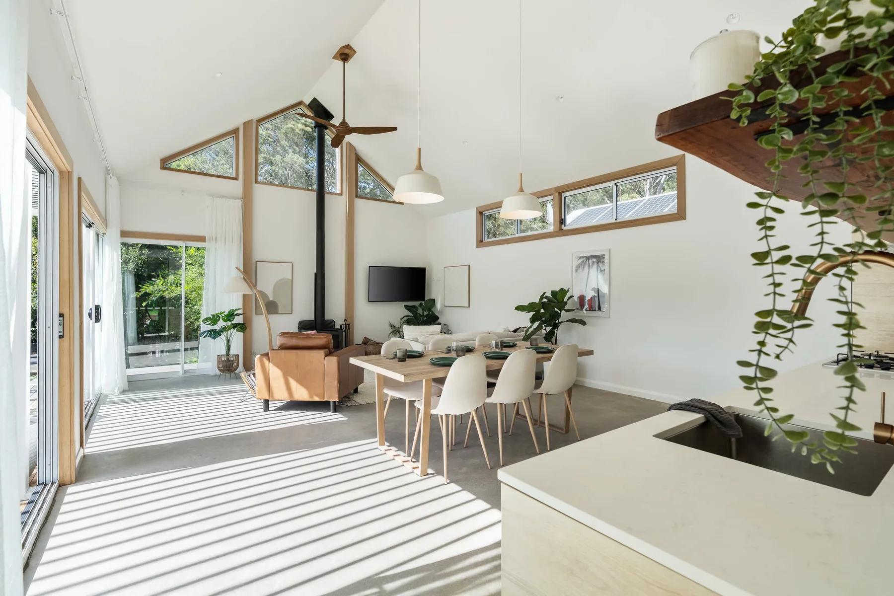 A bright open-plan living and dining area with a kitchen island.