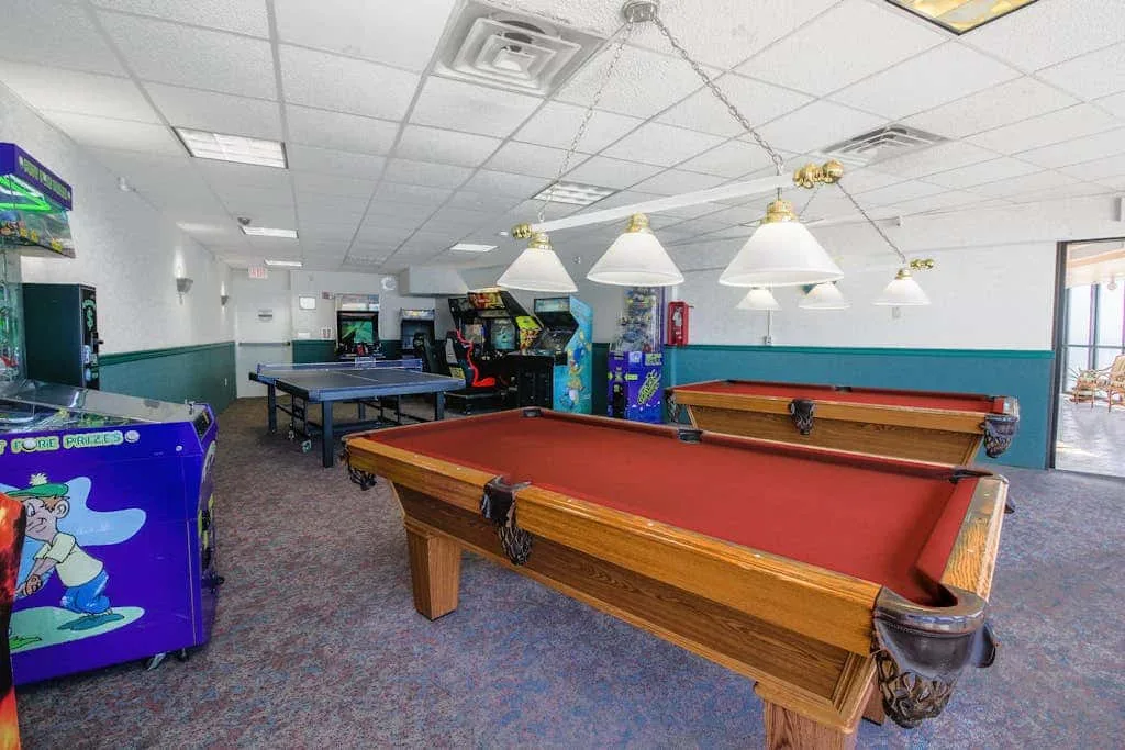 A recreation room with pool tables and arcade games.