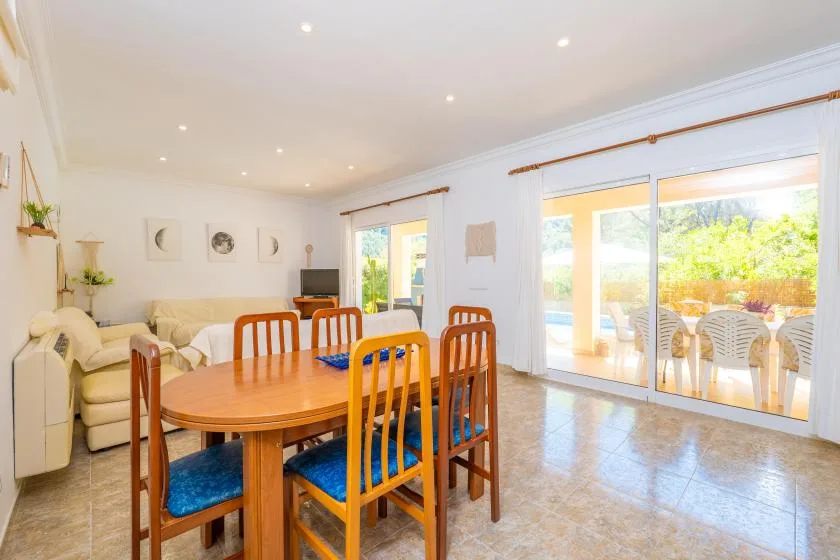 A bright dining and living area opens through large glass doors to a patio.