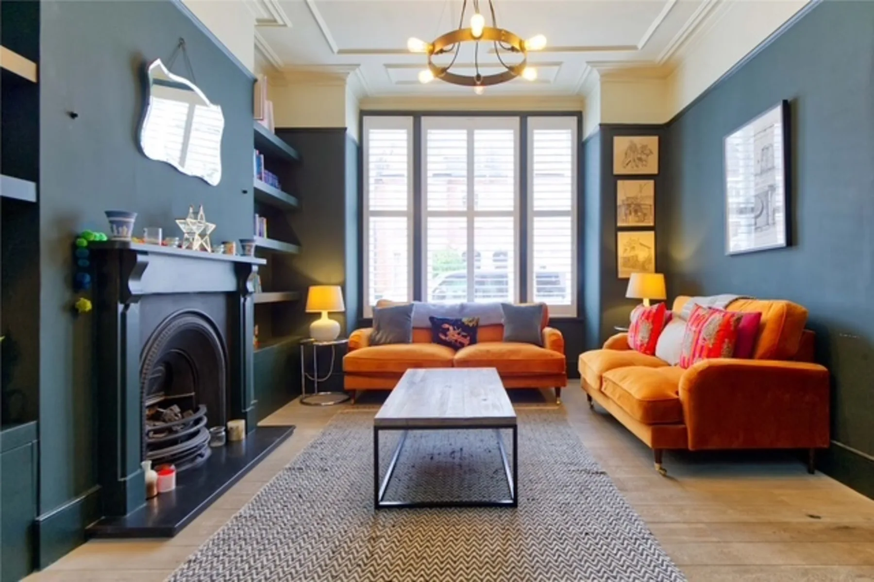 A living room with orange seating arranged around a coffee table.