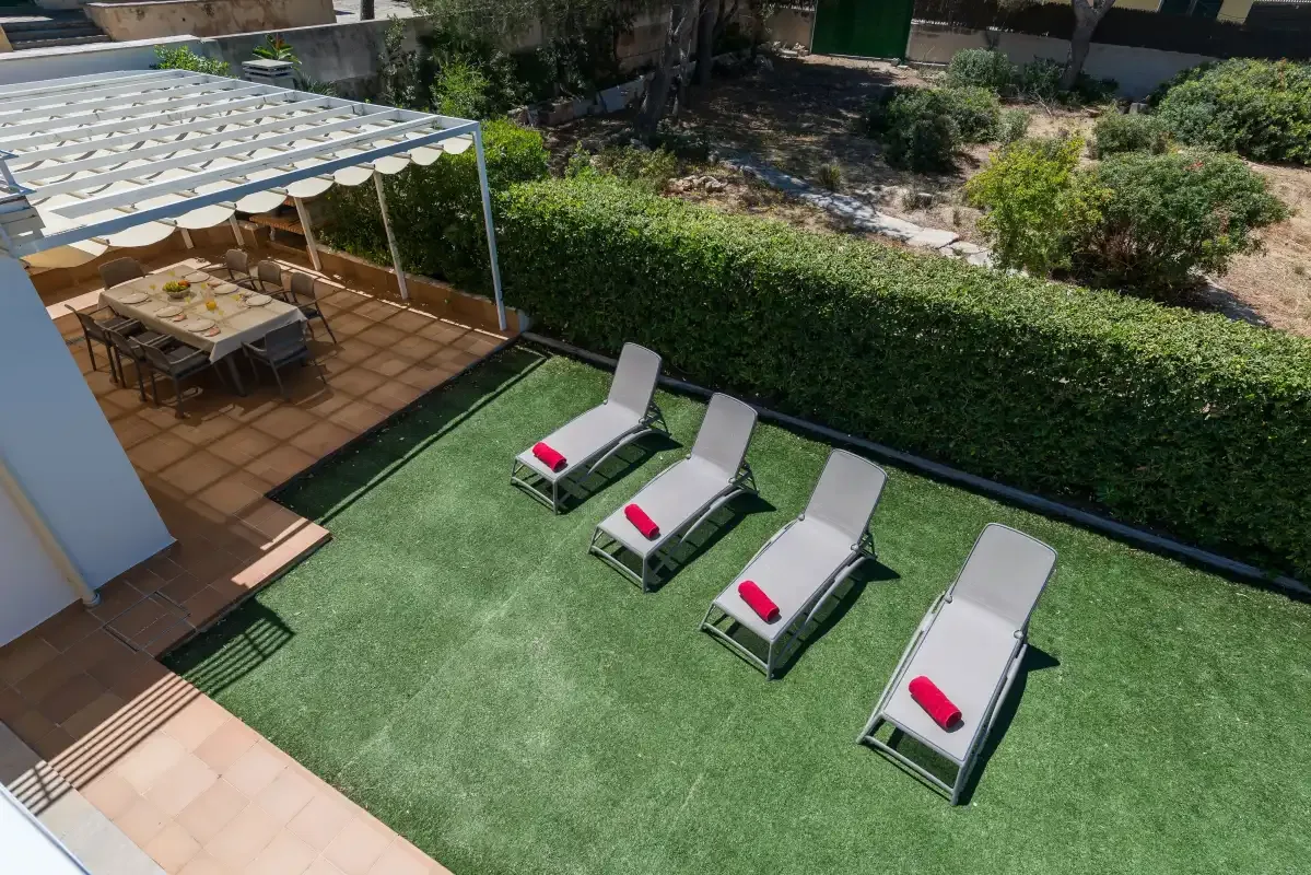 An outdoor patio with lounge seating beside a covered dining area.