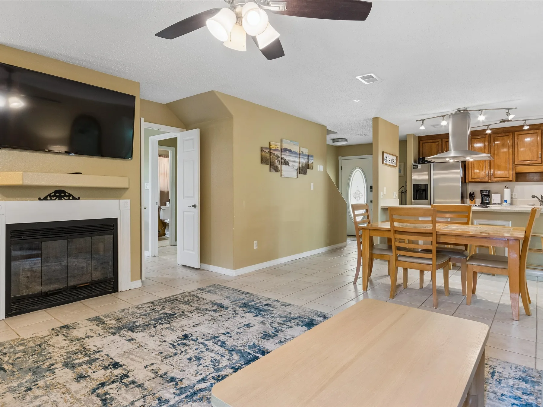 An open living and dining area with a fireplace and dining table.