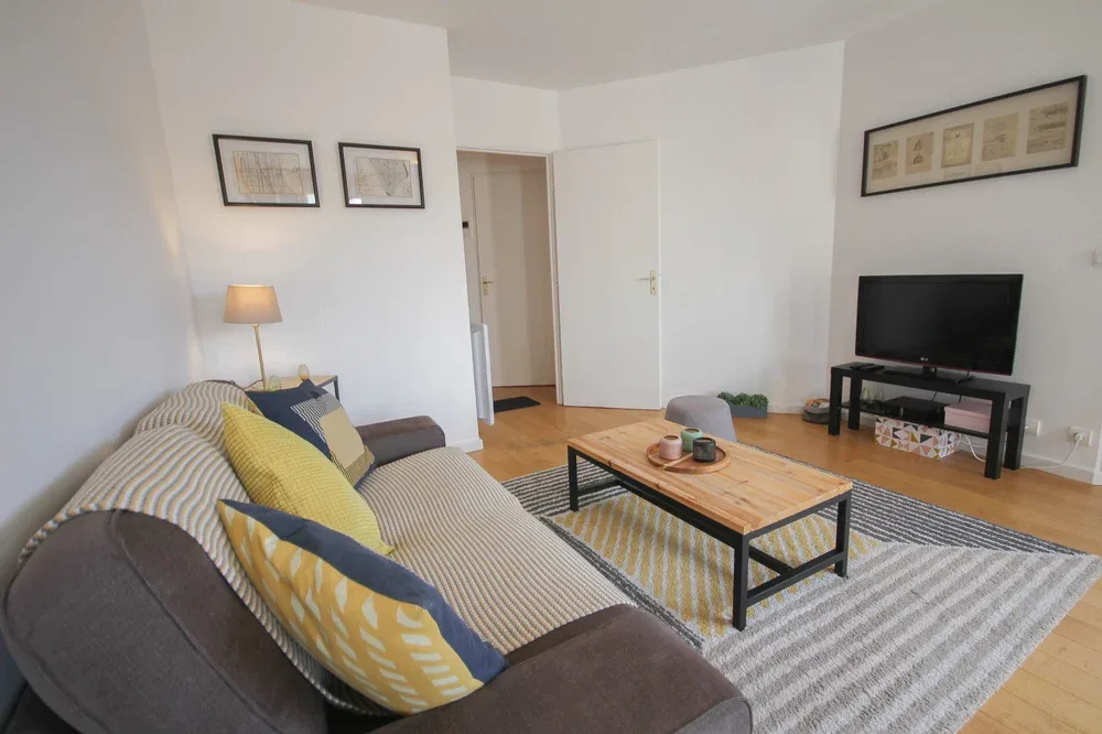 A living room with a striped sofa and a wooden coffee table.