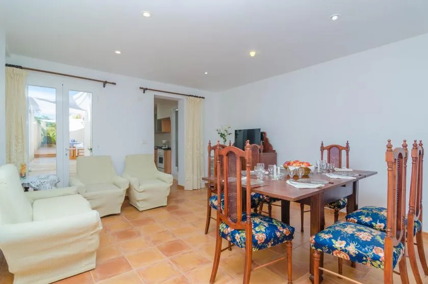 A dining and sitting area with a table set beside white seating.