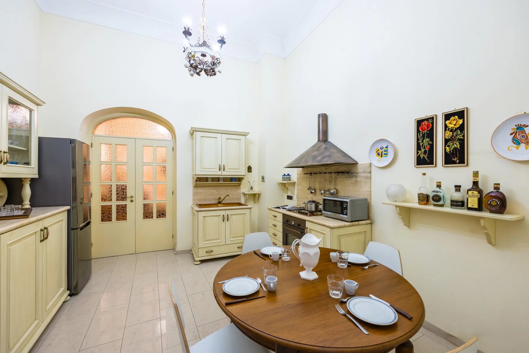 A dining area with a round table beside a kitchen.