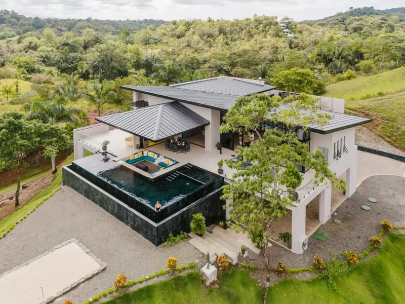 Casa Ama · 19. A contemporary villa with tiered swimming pools and open-air lounging spaces, integrated into a vibrant tropical forest setting.