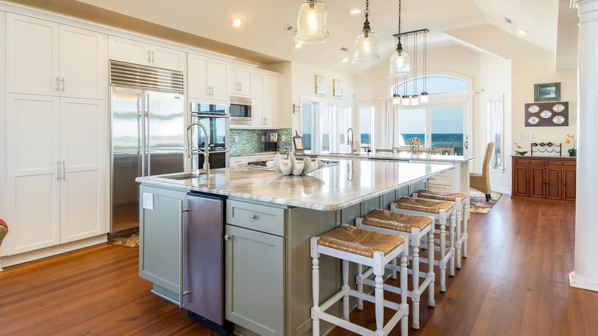 A bright kitchen with a large island and seating.