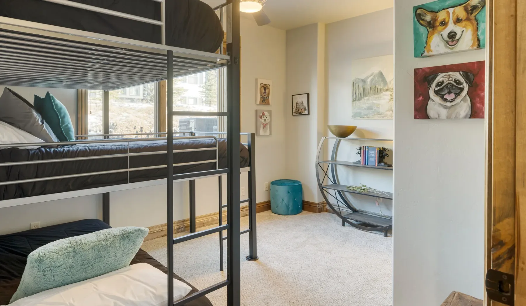 A bedroom with bunk beds, a curved bookshelf, and colorful animal artwork.