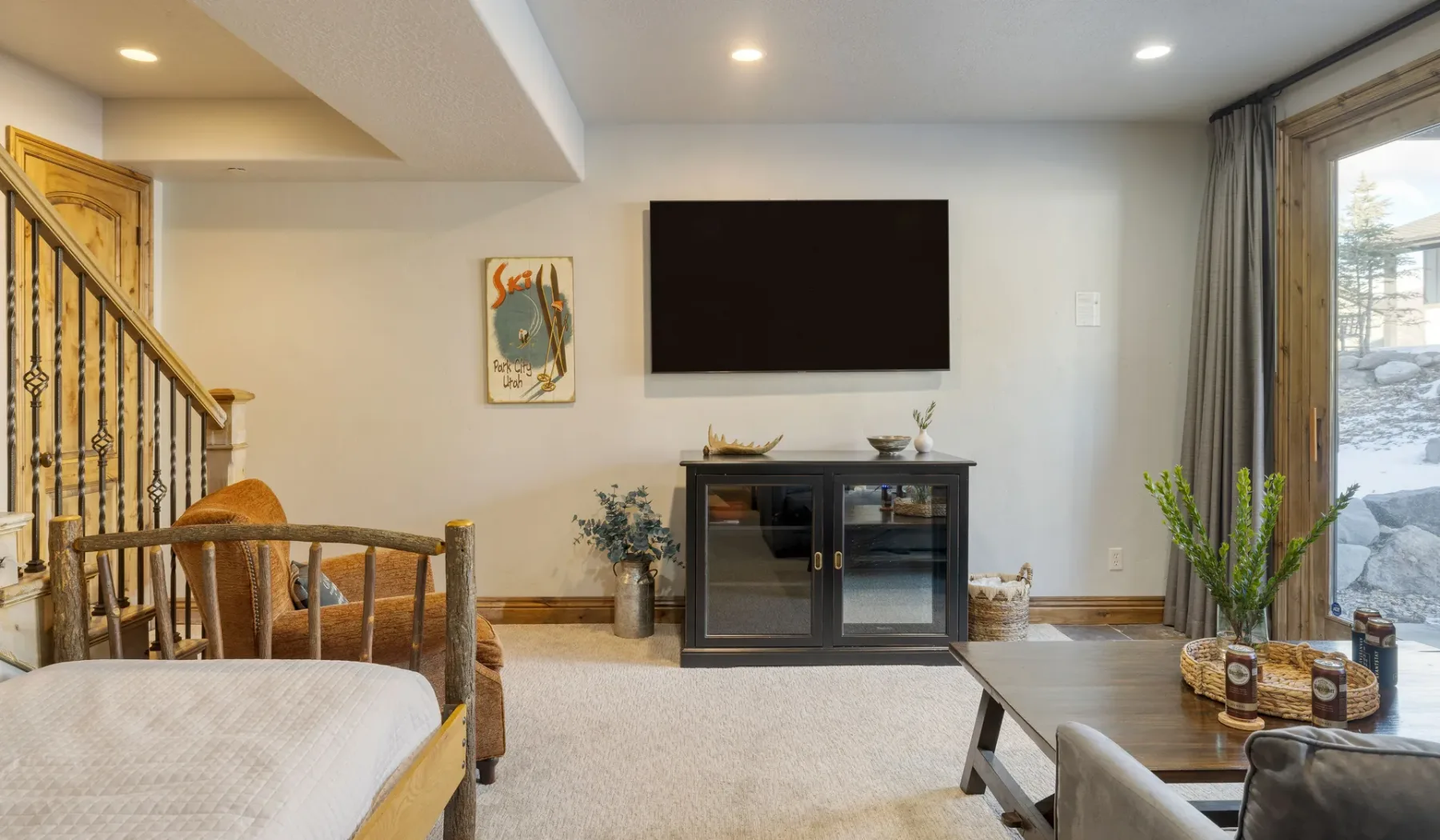 A living room with a television above a low cabinet and seating.