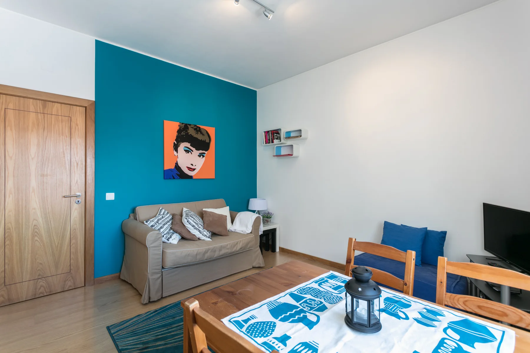 Una sala de estar con asientos, una mesa de comedor y un televisor.