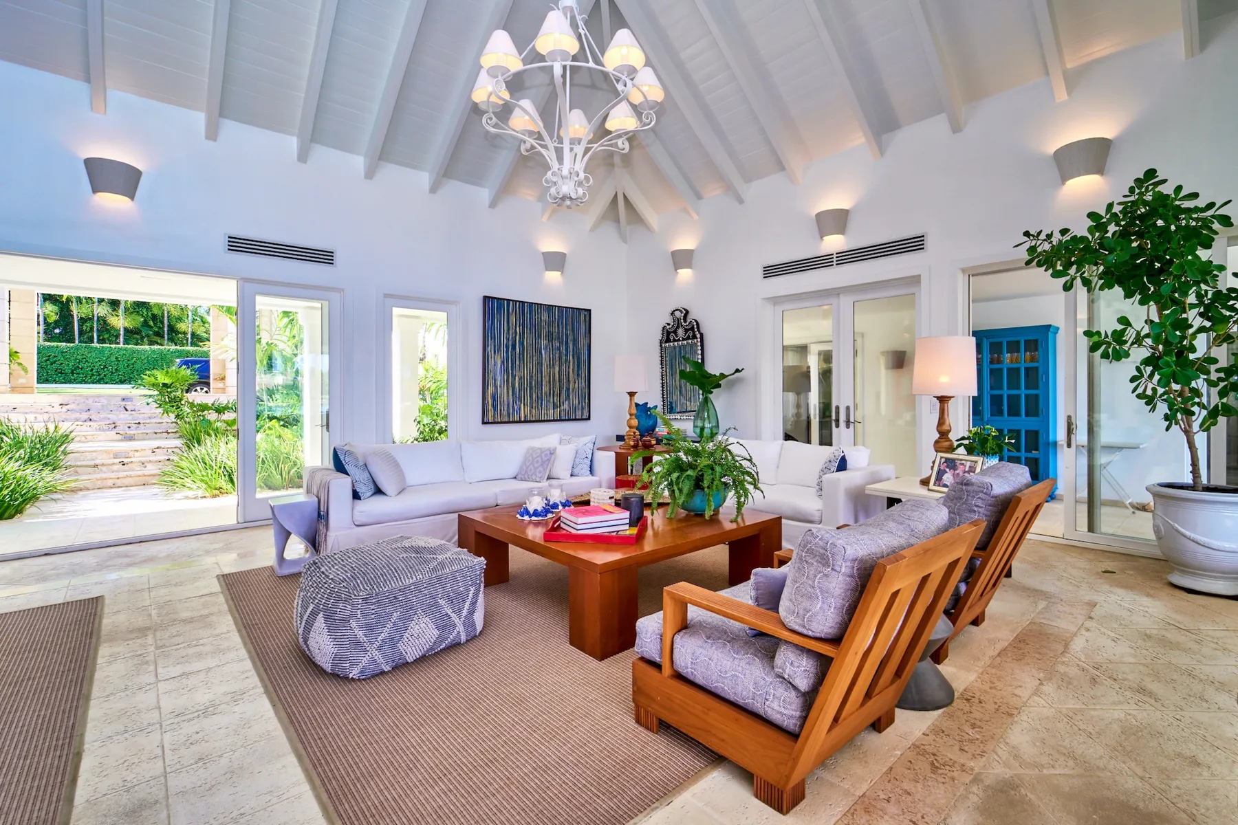 A bright living room with seating arranged around a wooden coffee table.