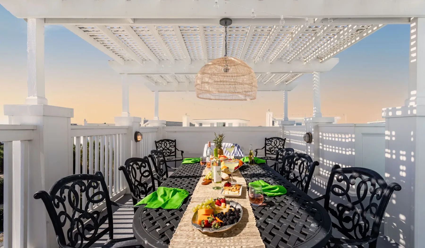 A dining table is set on a covered outdoor terrace.