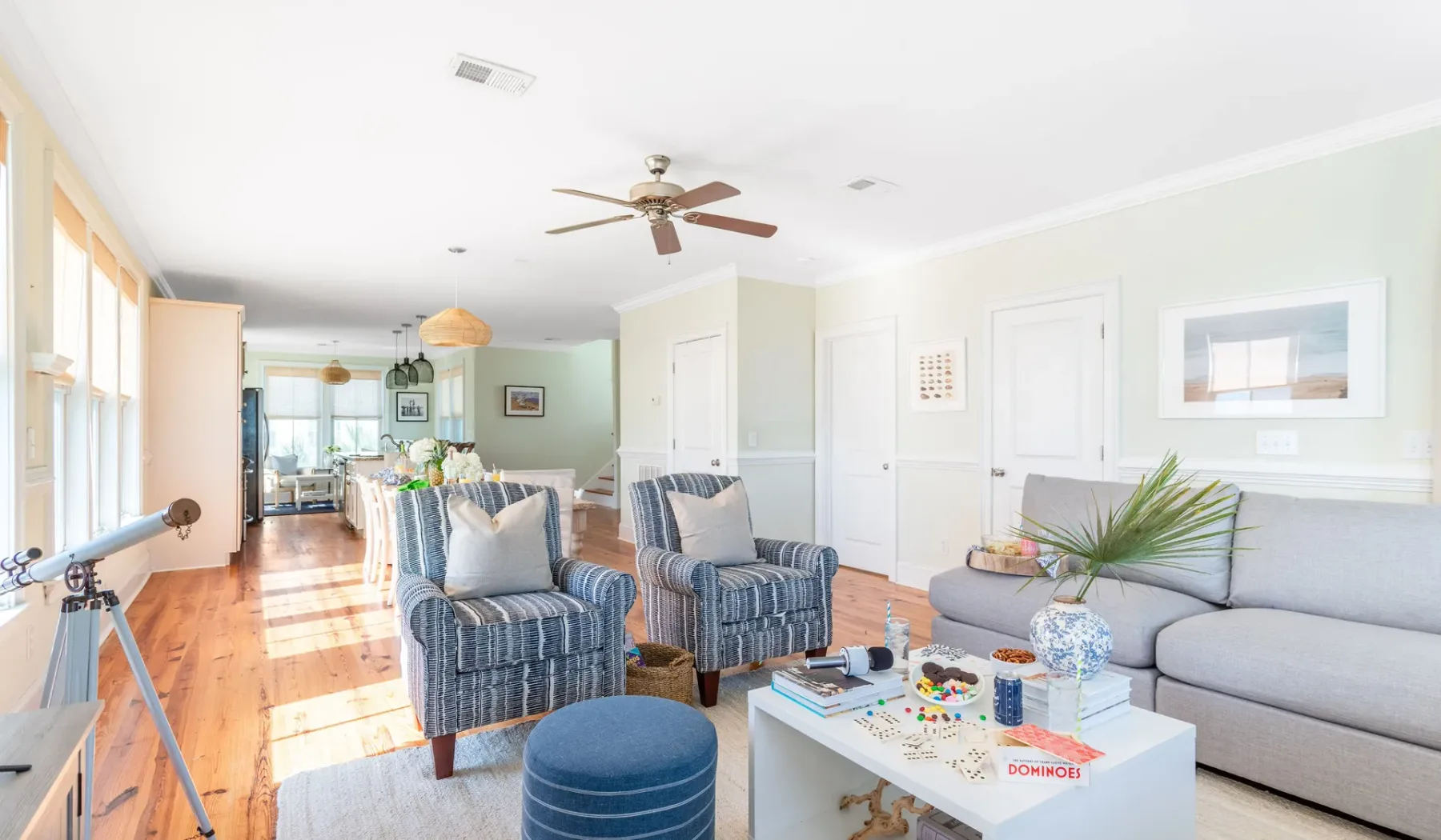 A bright living room with striped seating and a coffee table.