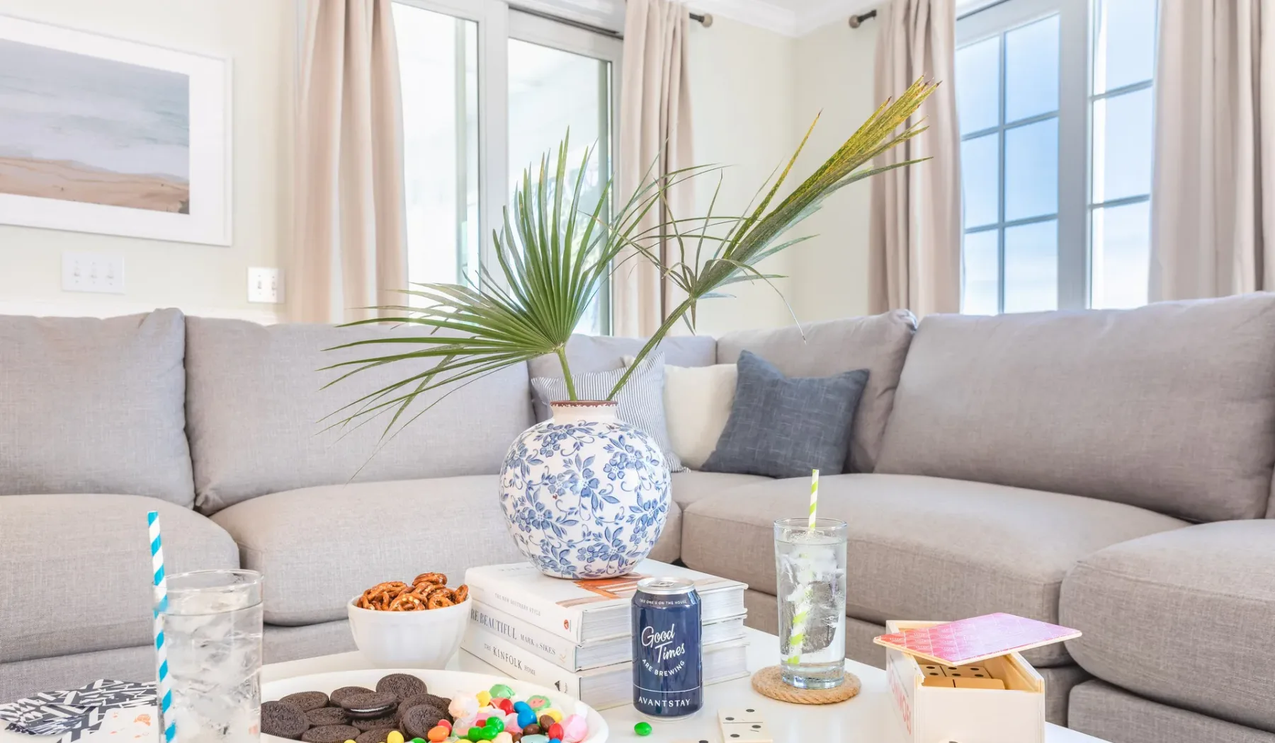 A bright living room with a sectional seating area and a glass coffee table.