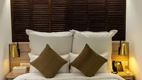 A guest room with a bed and bedside tables.